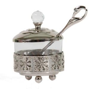 Honey pot with a delicate ethnic look combined with glass and silver-colored metal