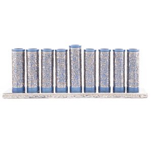 Menorah of blue metal rolls wrapped with metal cutouts of pomegranates